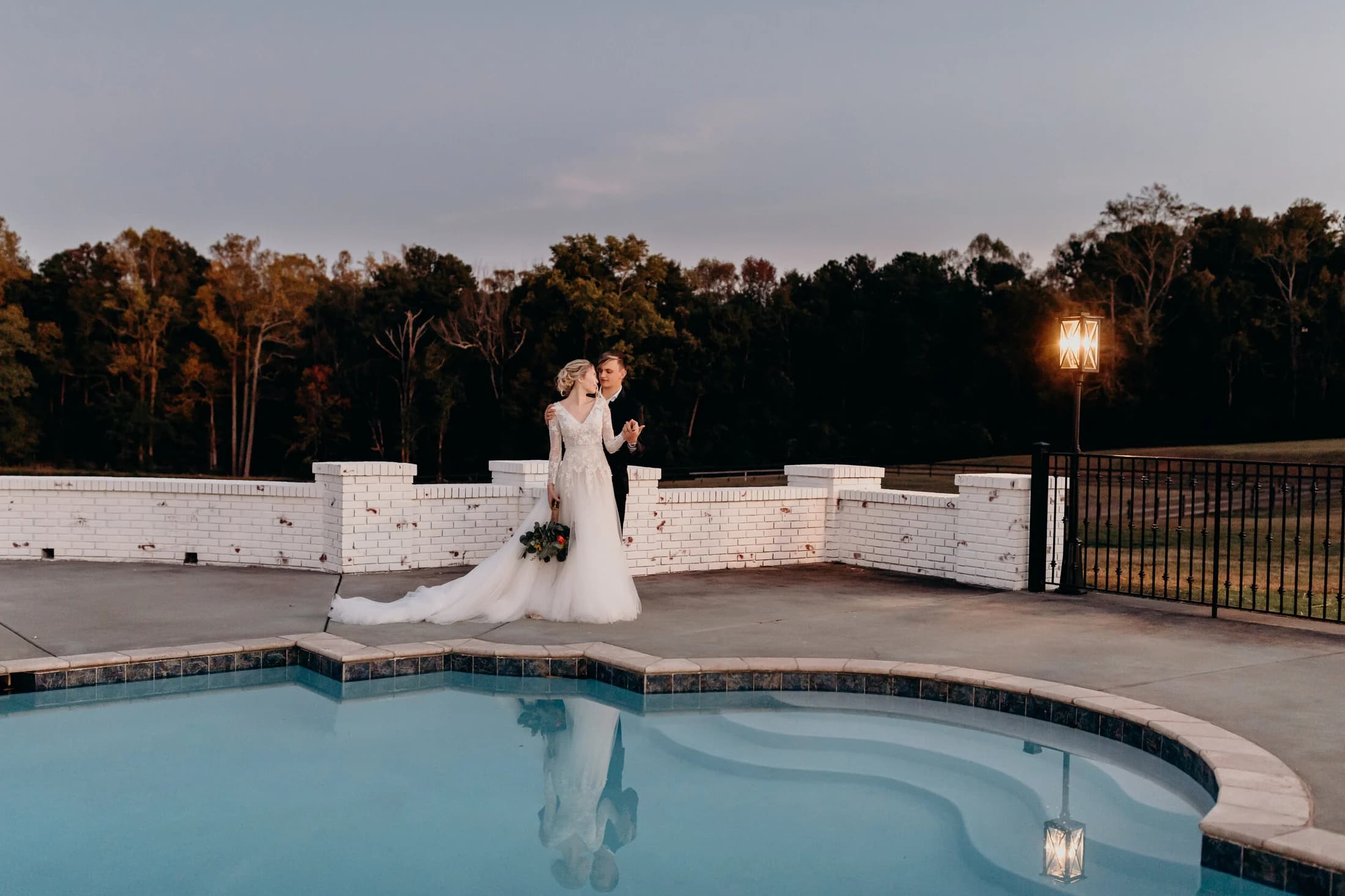 Couple poolside sunset at White Fallow Estate