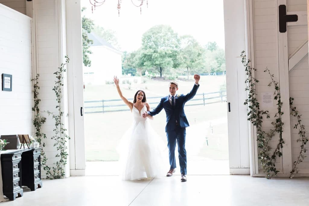 A couple celebrating in the open barn doors