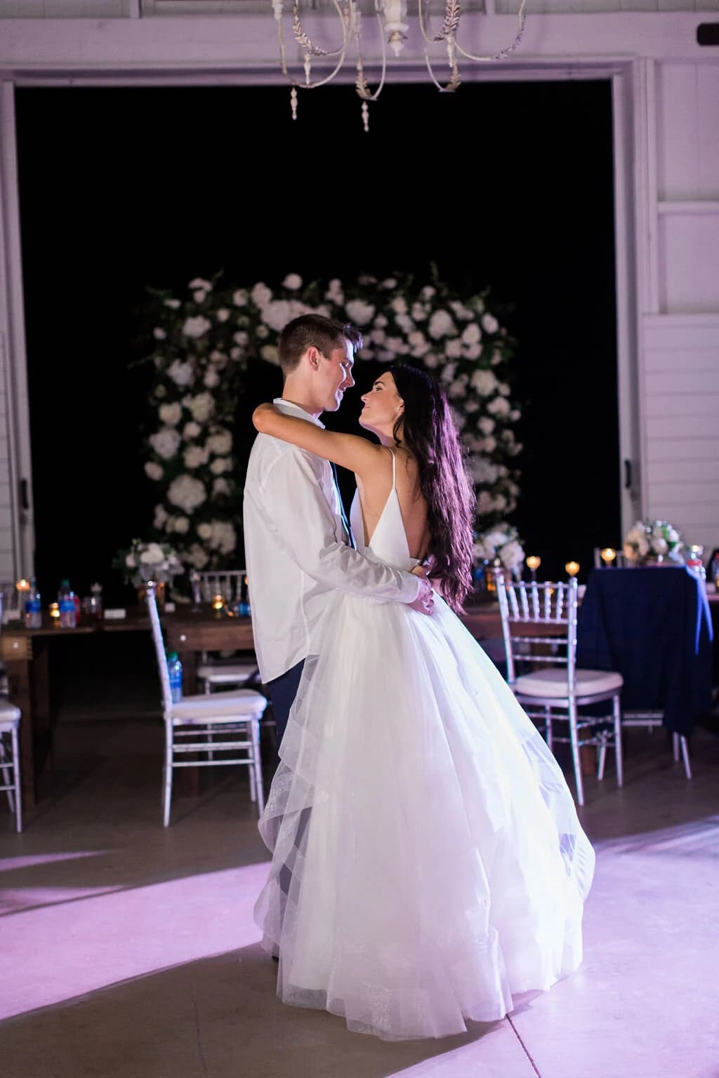 A first dance under the barn chandeliers