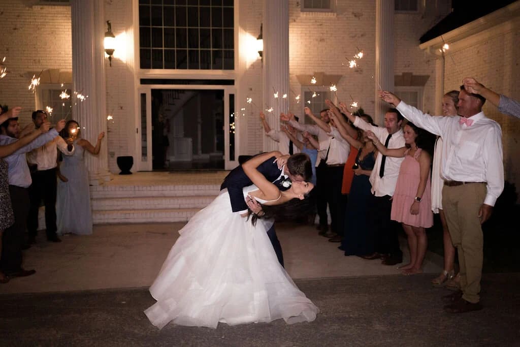 A sparkler send-off outside the mansion